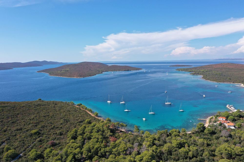 Croatian islands close together, with sailing yachts at anchor in the bay