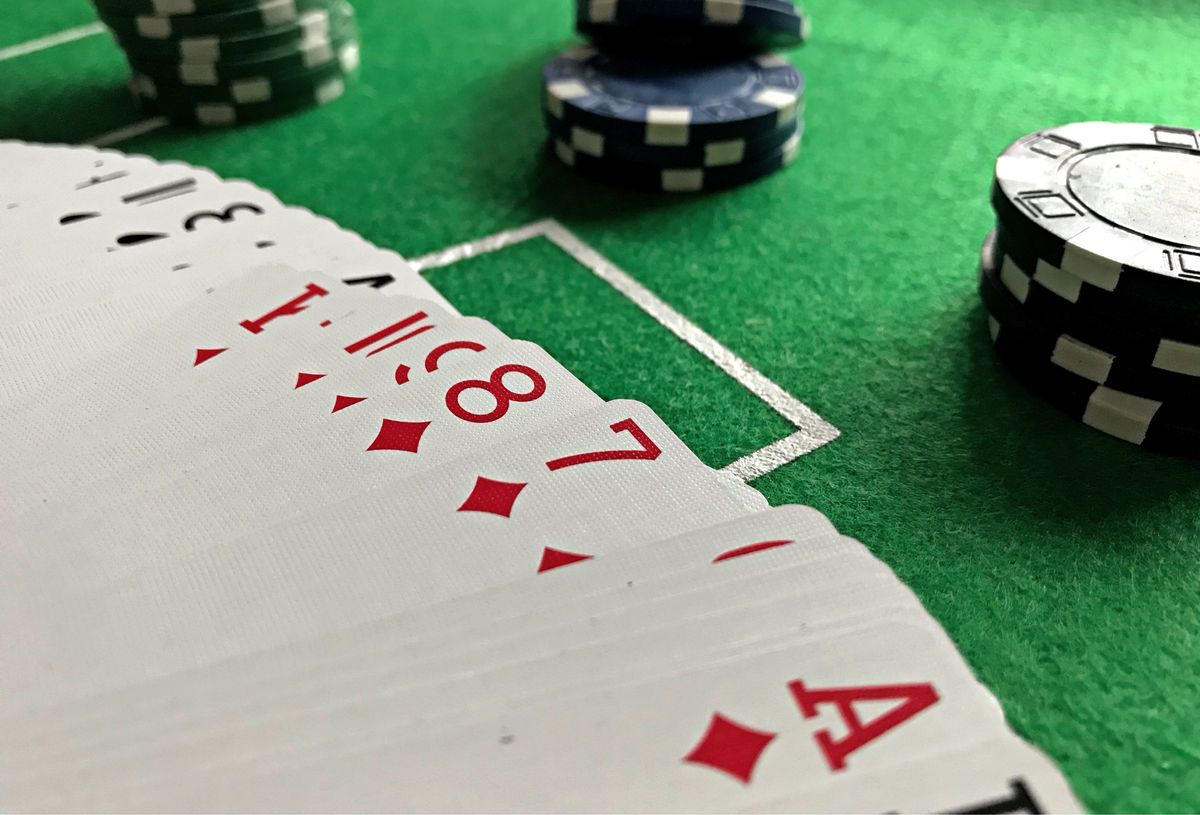 Playing cards and poker chips on green felt